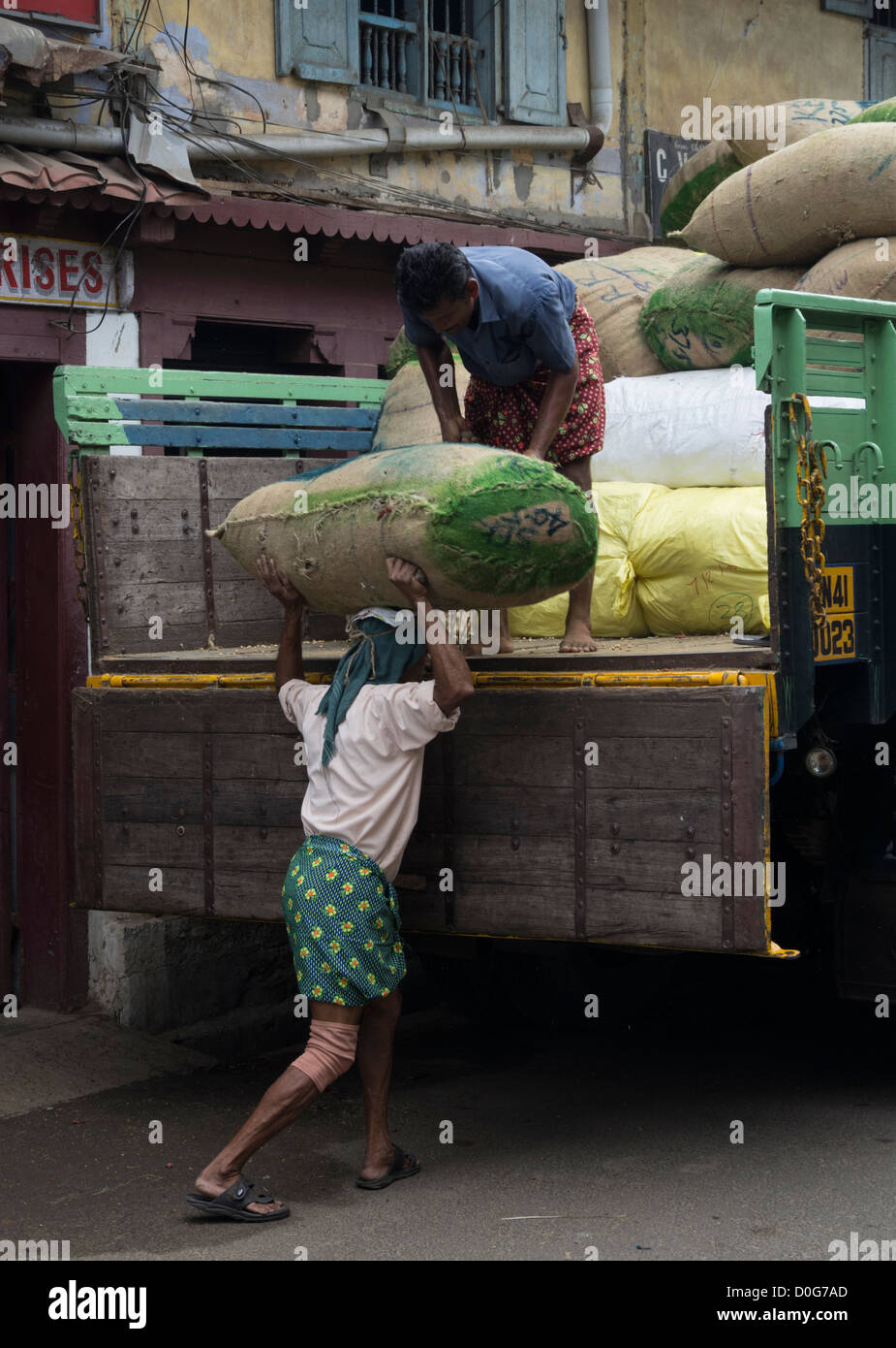 Workers loading sacks of rice onto a lorry in Cochin, Kerala, India Stock Photo