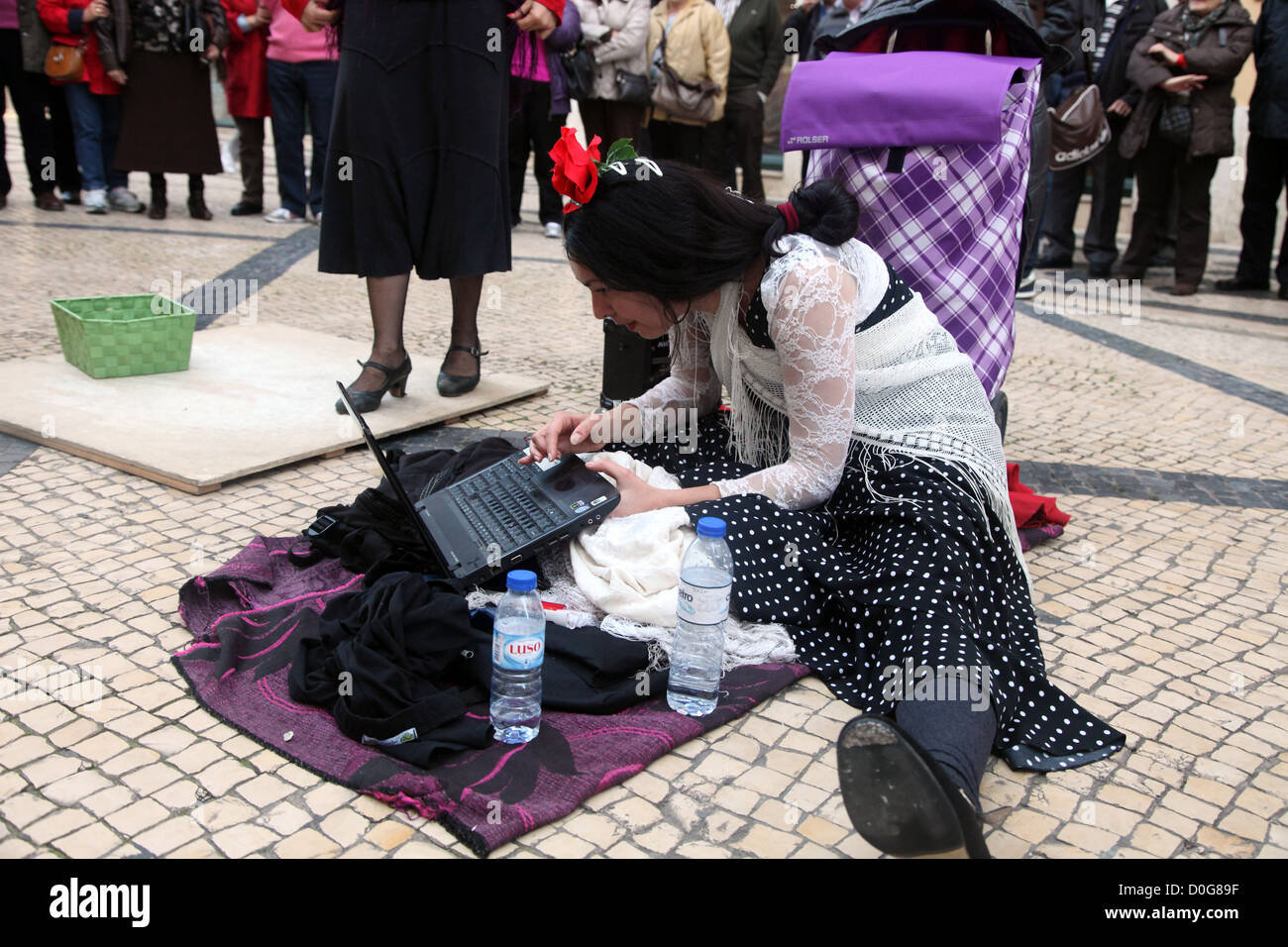 Lisbon street performer checks her e-mail Stock Photo