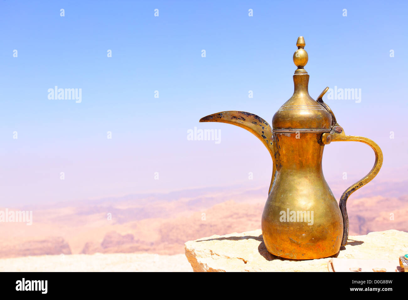 Arabic coffee pot on the stone and Jordan's mountains in the background Stock Photo