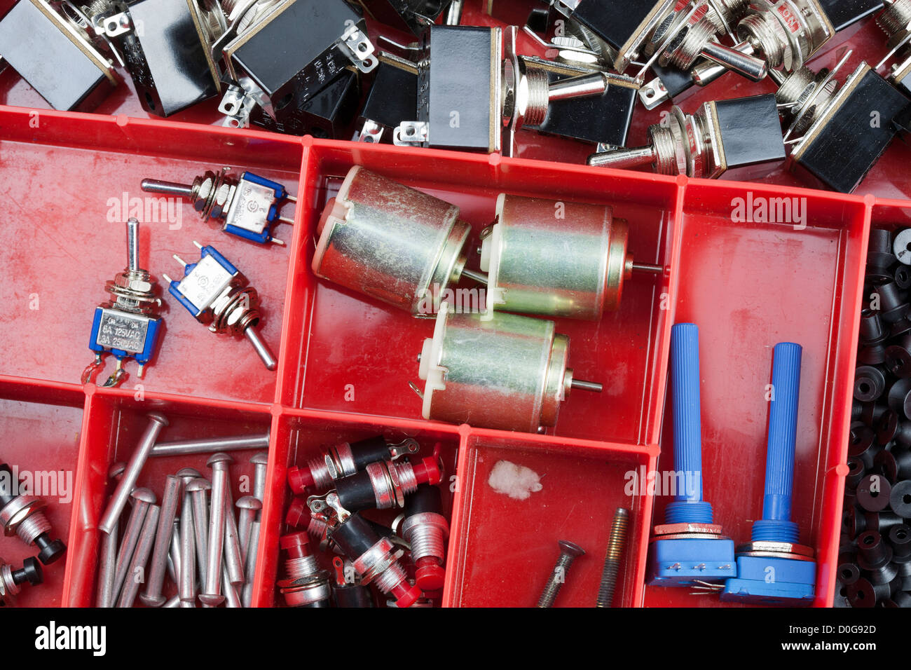 Close up of potentiometer switches motors and capacitors Boxed