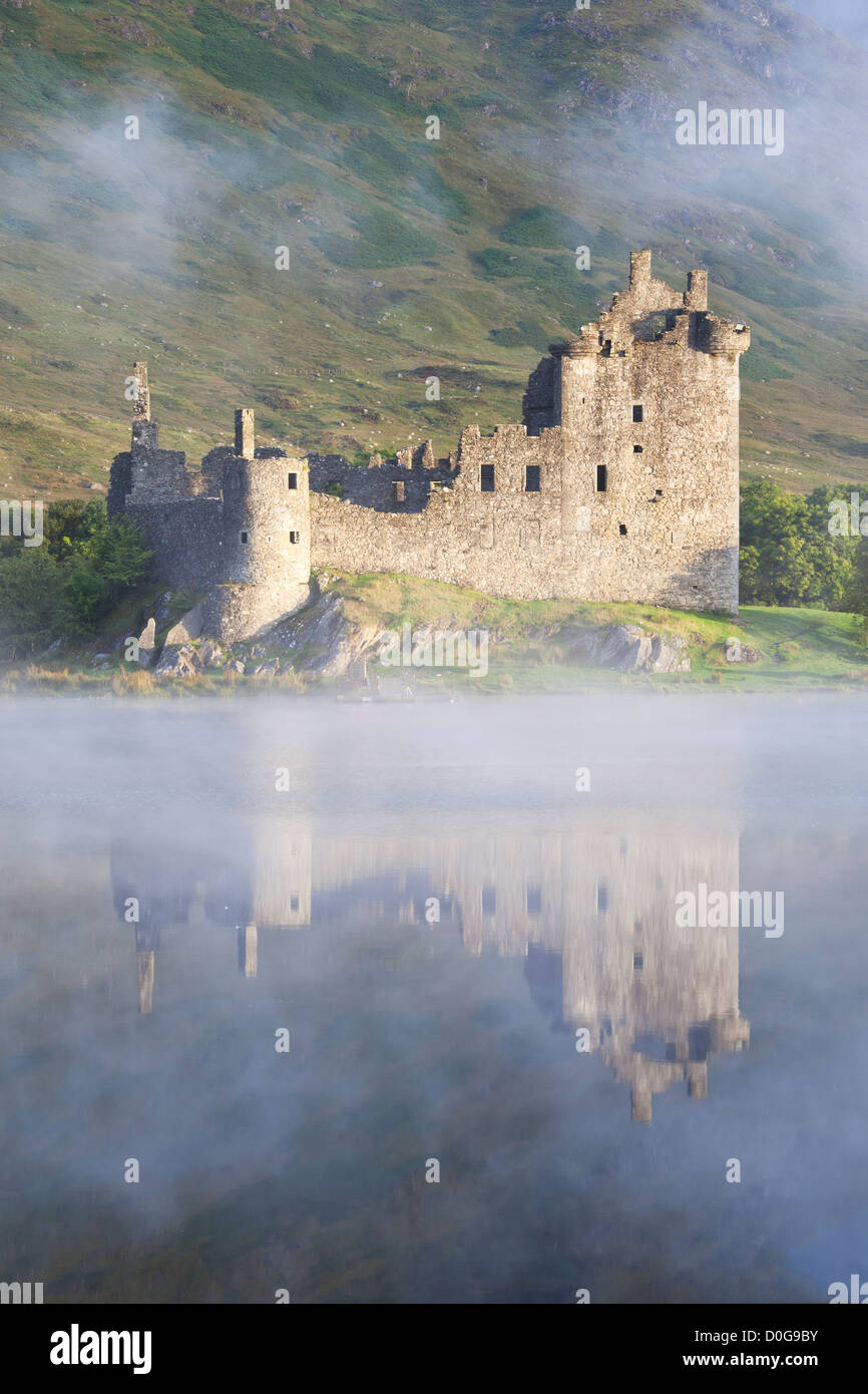 The dramatic ruins of Kilchurn Castle reflected in the flat calm waters of Loch Awe, Argyll, The Highlands, Scotland, UK Stock Photo