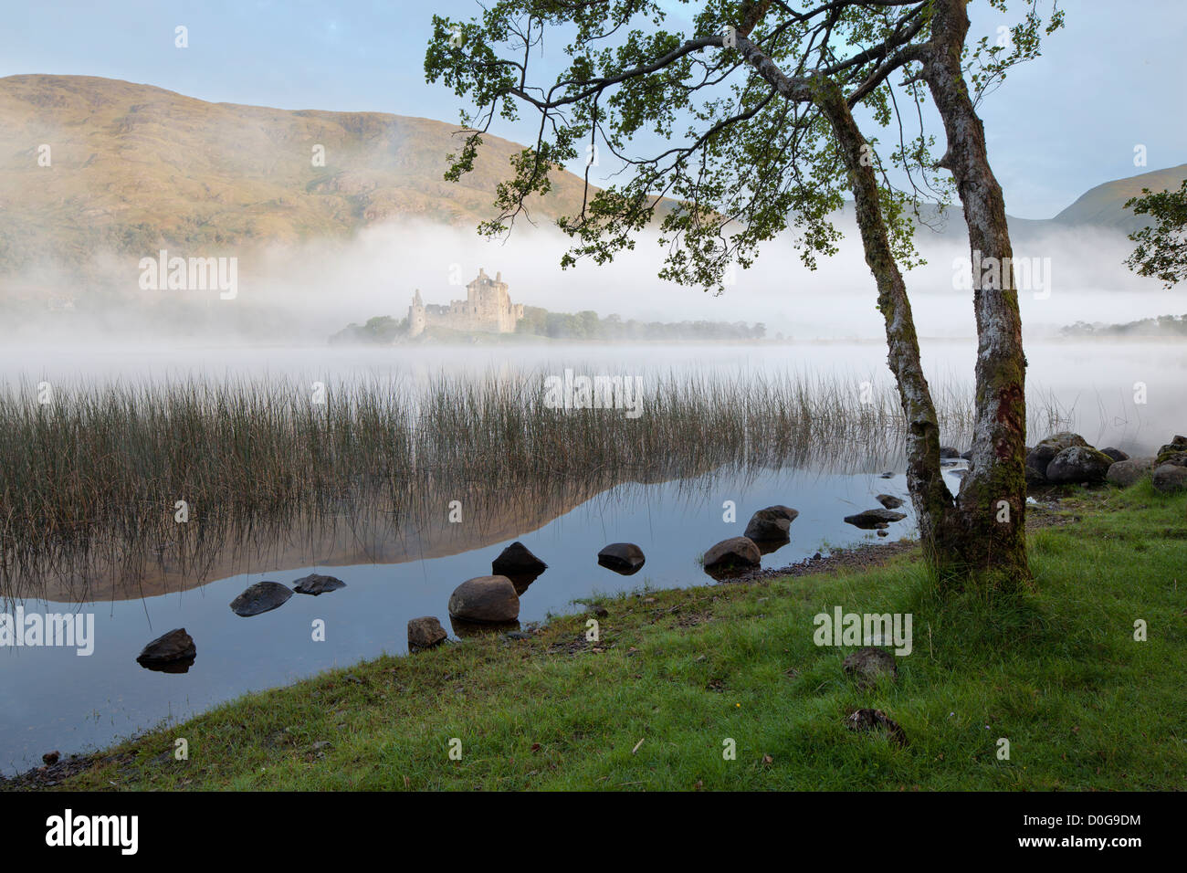 Mist shrouded Kilchurn Castle viewed from the banks of Loch Awe, Argyll and Bute, The Highlands, Scotland, UK Stock Photo