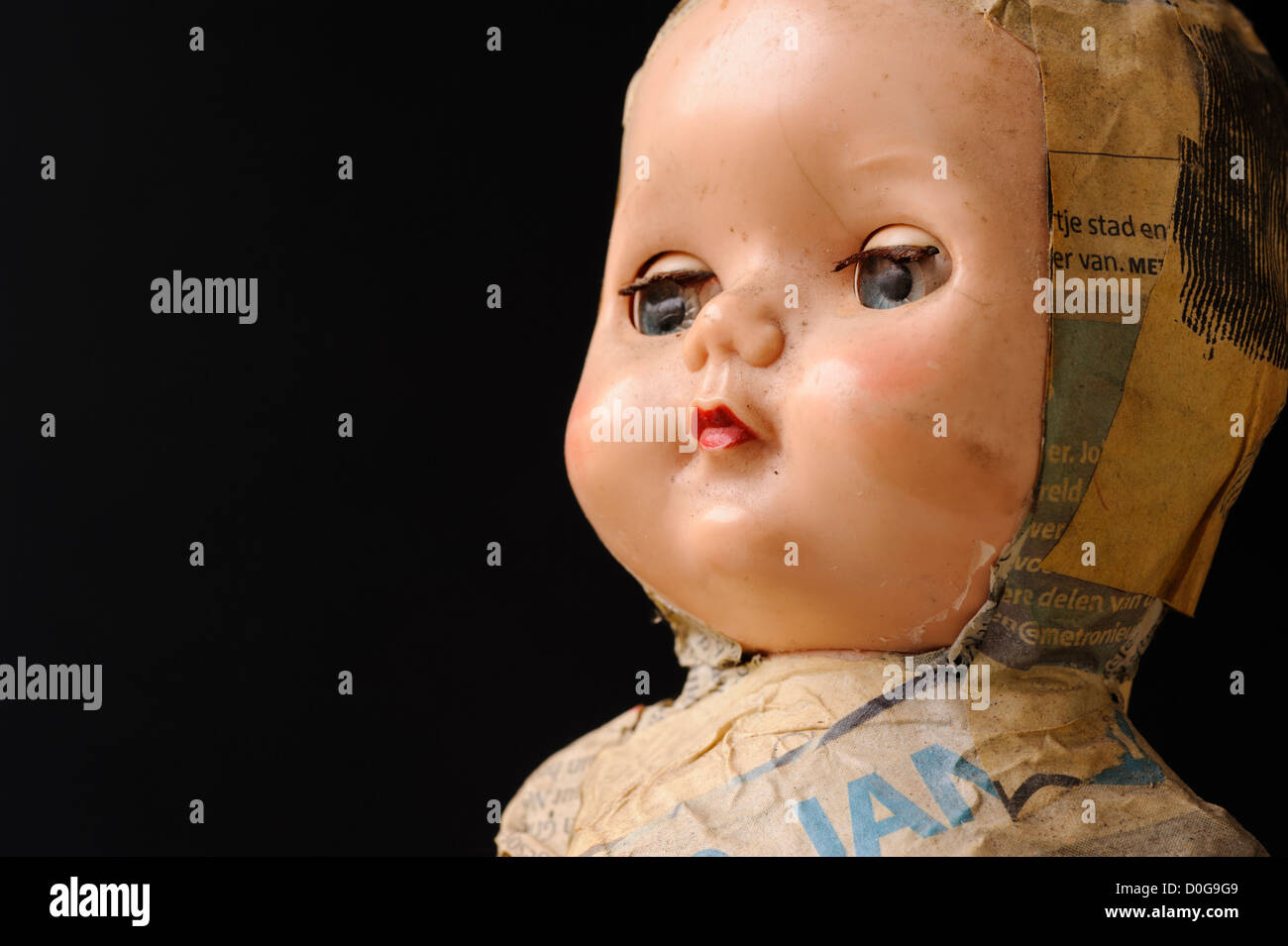 Close up of doll face on black background Stock Photo