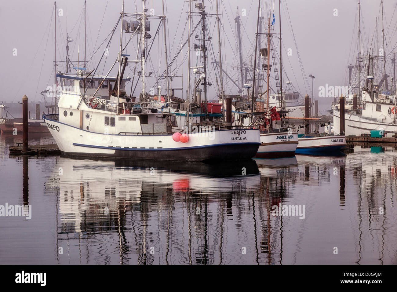 Morning fog begins to lift revealing Oregon’s Yaquina Bay Fishing fleet