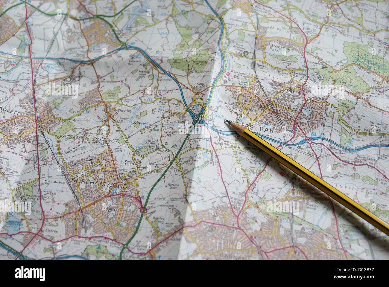 Pencil resting on local map, to plan a route Stock Photo