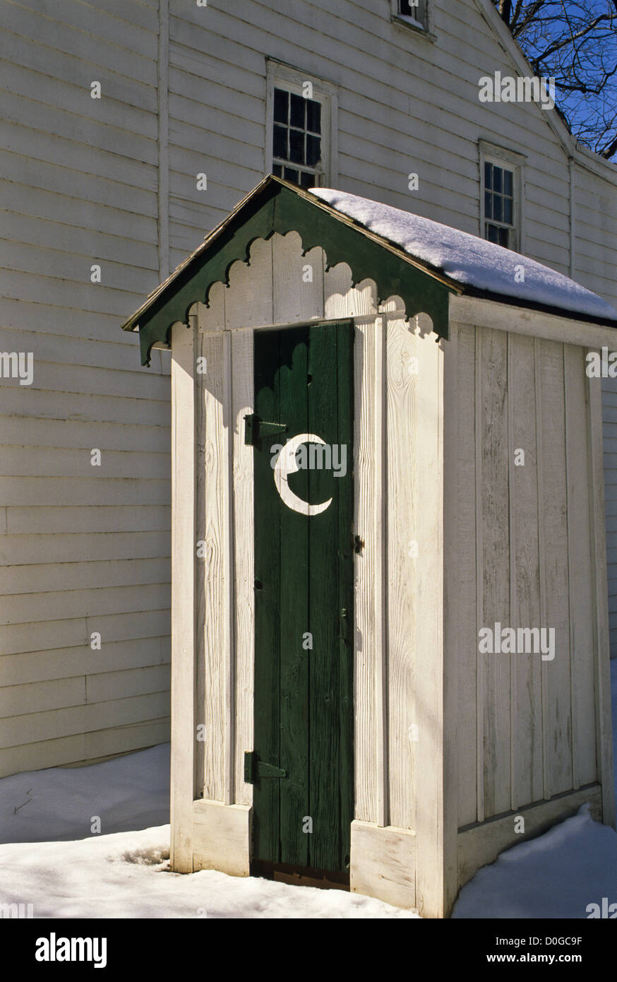 Historic outhouse door with a quarter moon face in snow, NJ, New Stock