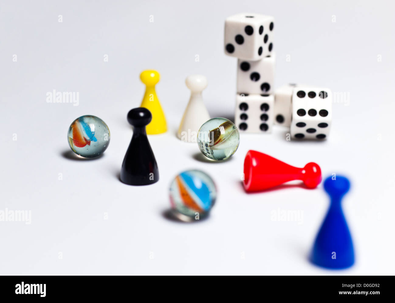Still life setup of children's toys on table top dominoes dice and game pieces Stock Photo