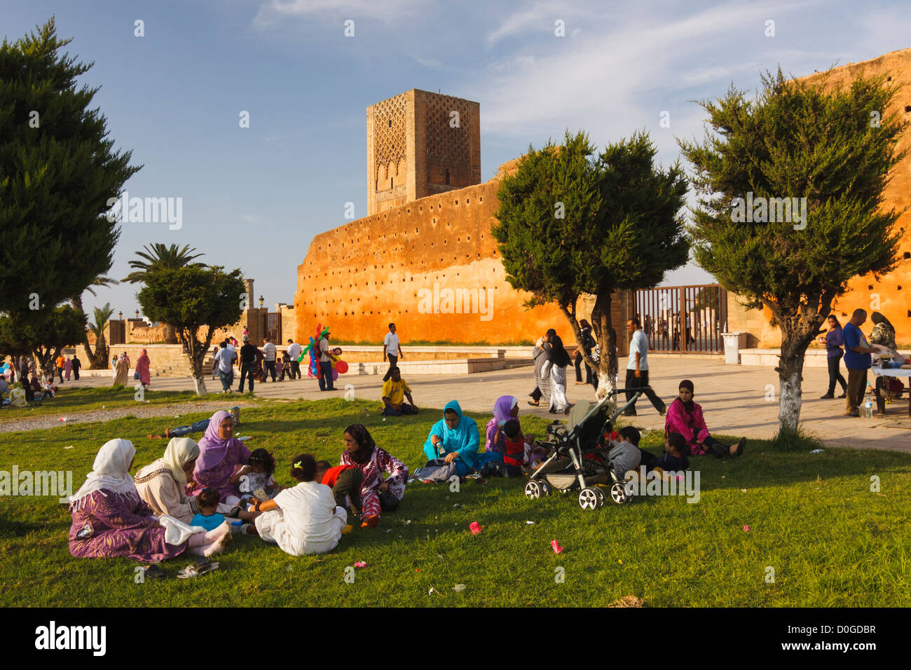 Moroccan women sitting on the gardens around the Hassan Tower premises. Rabat, Morocco Stock Photo