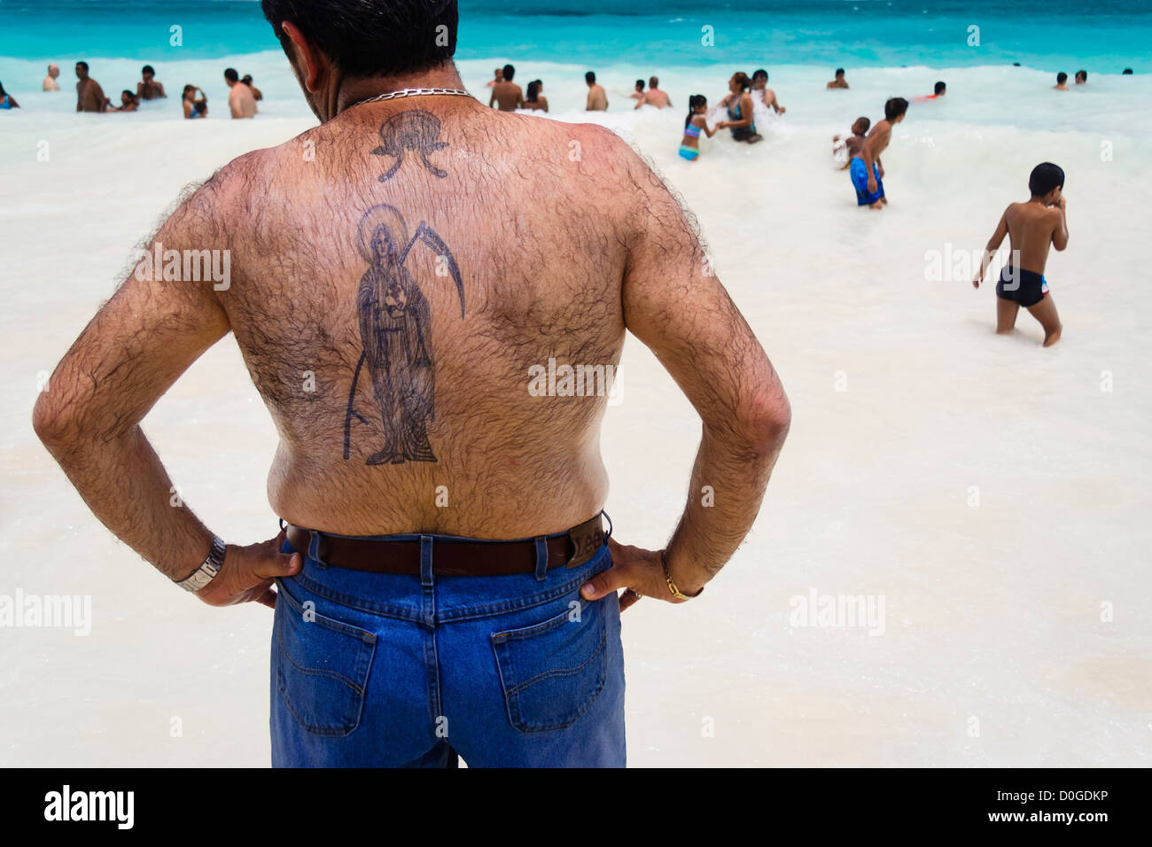 Tattooed Santa Muerte devotee in Tulum beach, Yucatan, Mexico Stock Photo