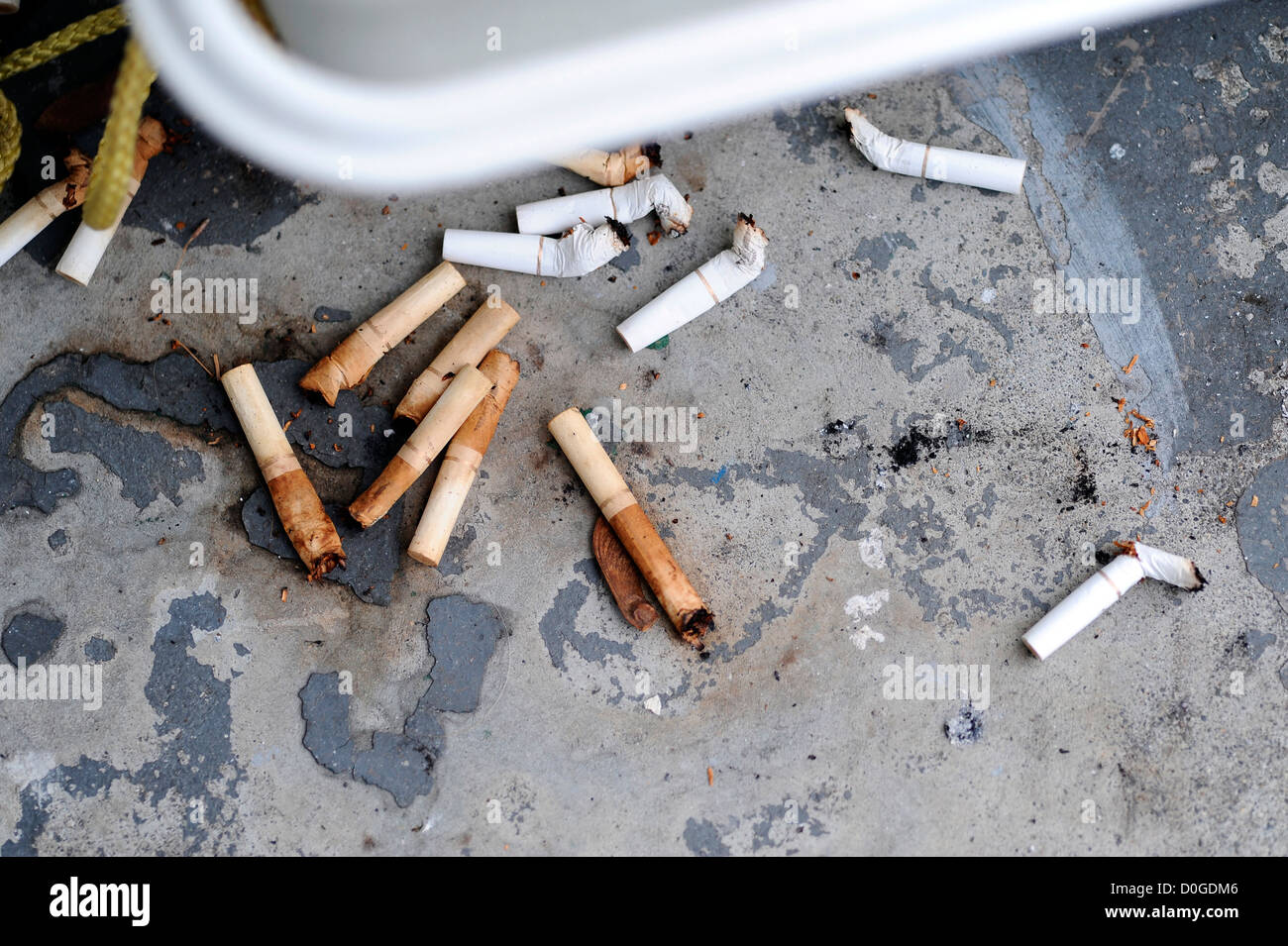 Old cigarette butts spread on the ground Stock Photo