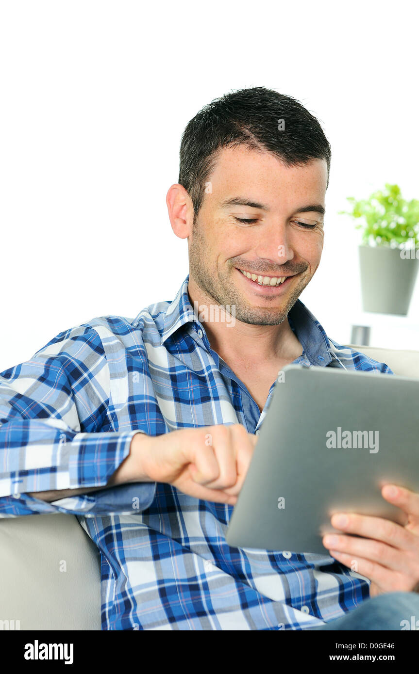 attractive relaxed and positive man is surfing on his tablet Stock Photo