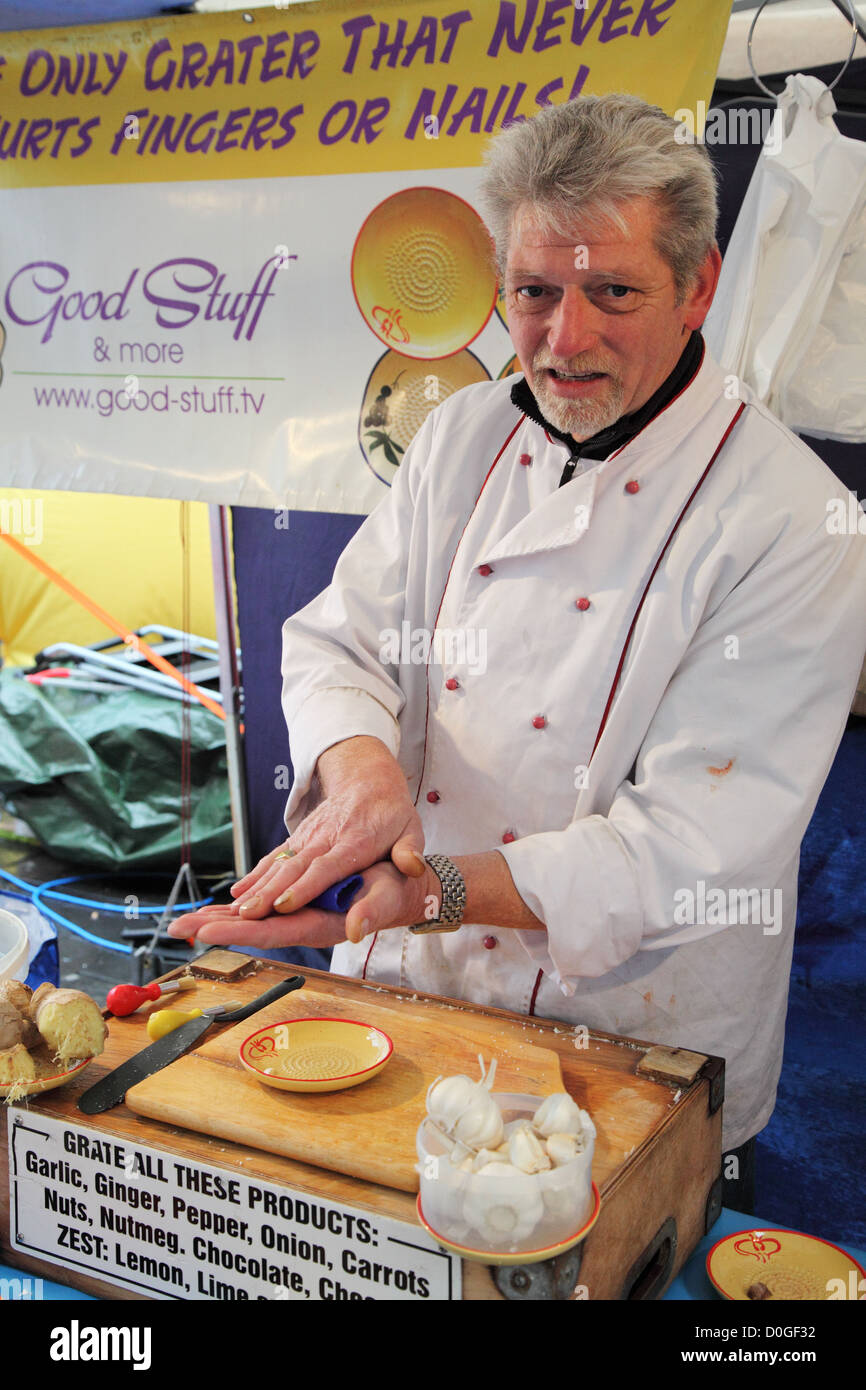 Dutch market trader demonstrating product at Newcastle Continental Market north east England UK Stock Photo