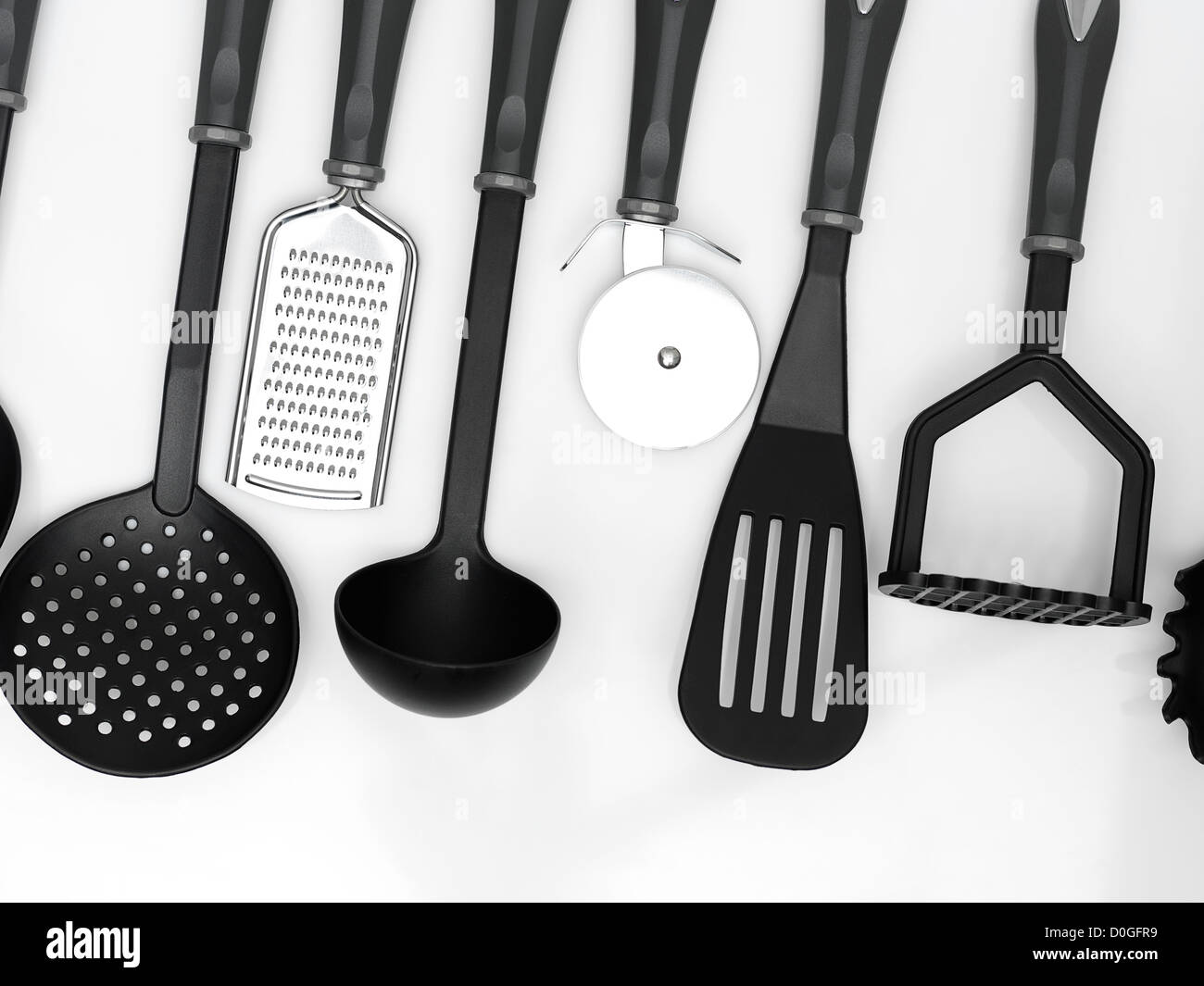 kitchen utensils hanging white background Stock Photo