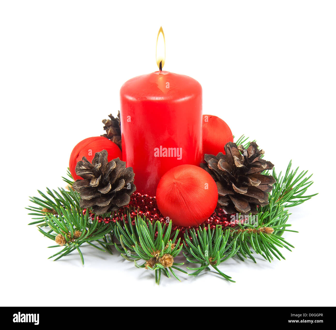 Christmas decoration with red candle, pine cones, spruce branches on white background Stock Photo