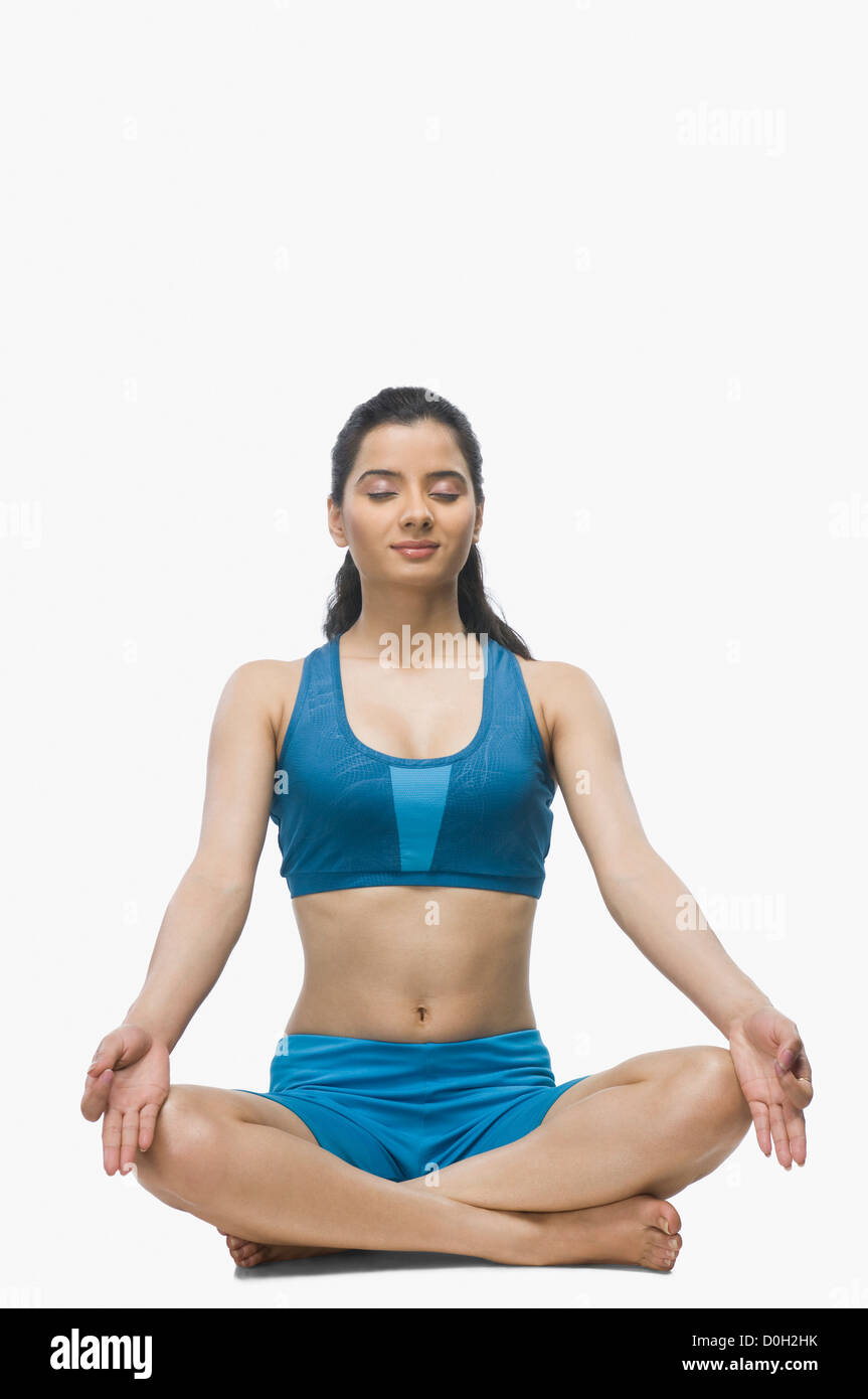 Young woman practicing yoga against white background Stock Photo - Alamy