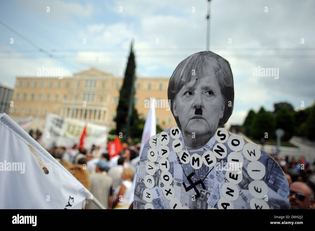 Anti-Merkel banner during a anti-austerity protest in Athens' Syntagma square, in front of Greece's Parliament, in October 2012. Stock Photo