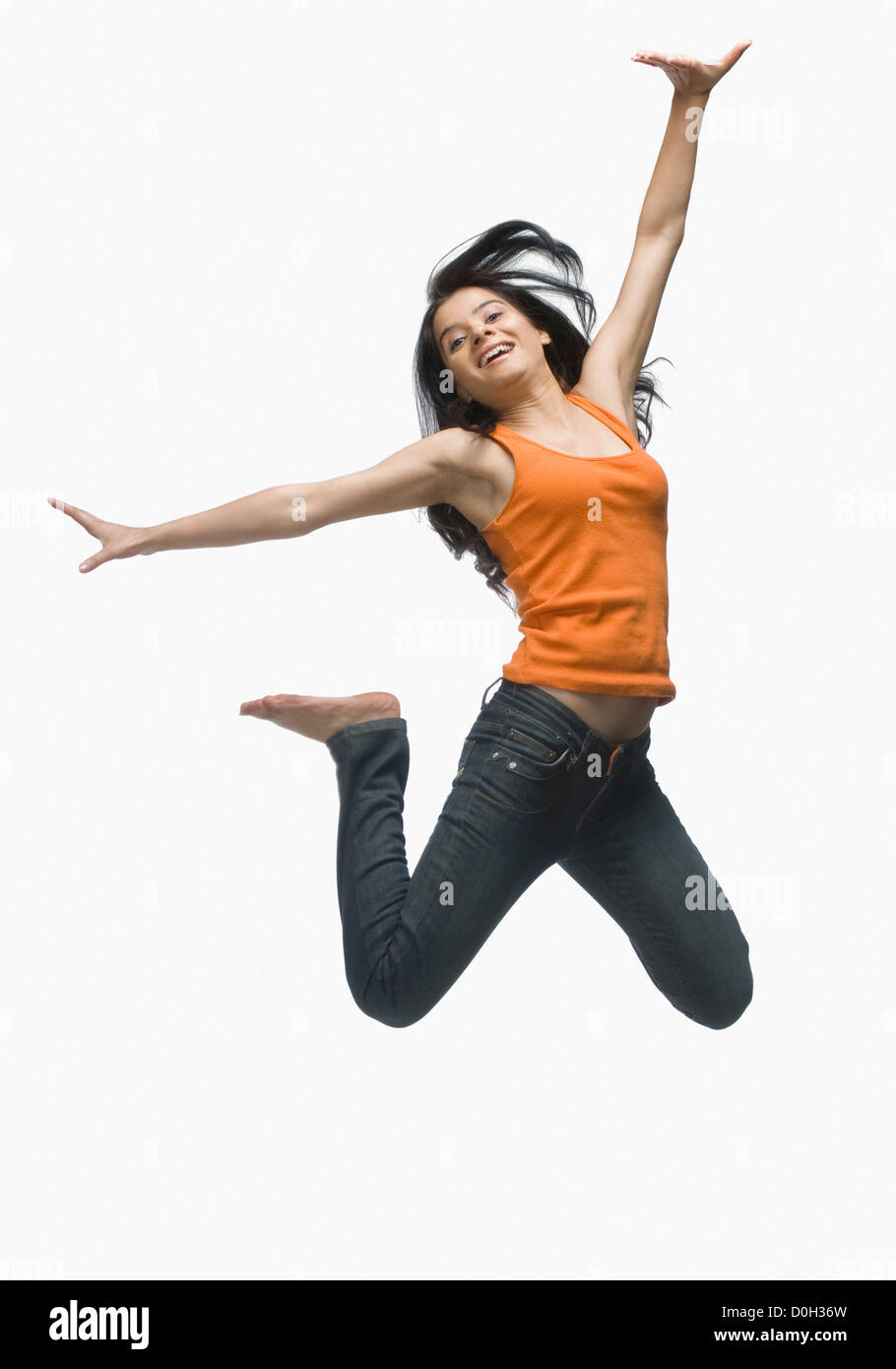 Young woman jumping against white background Stock Photo - Alamy