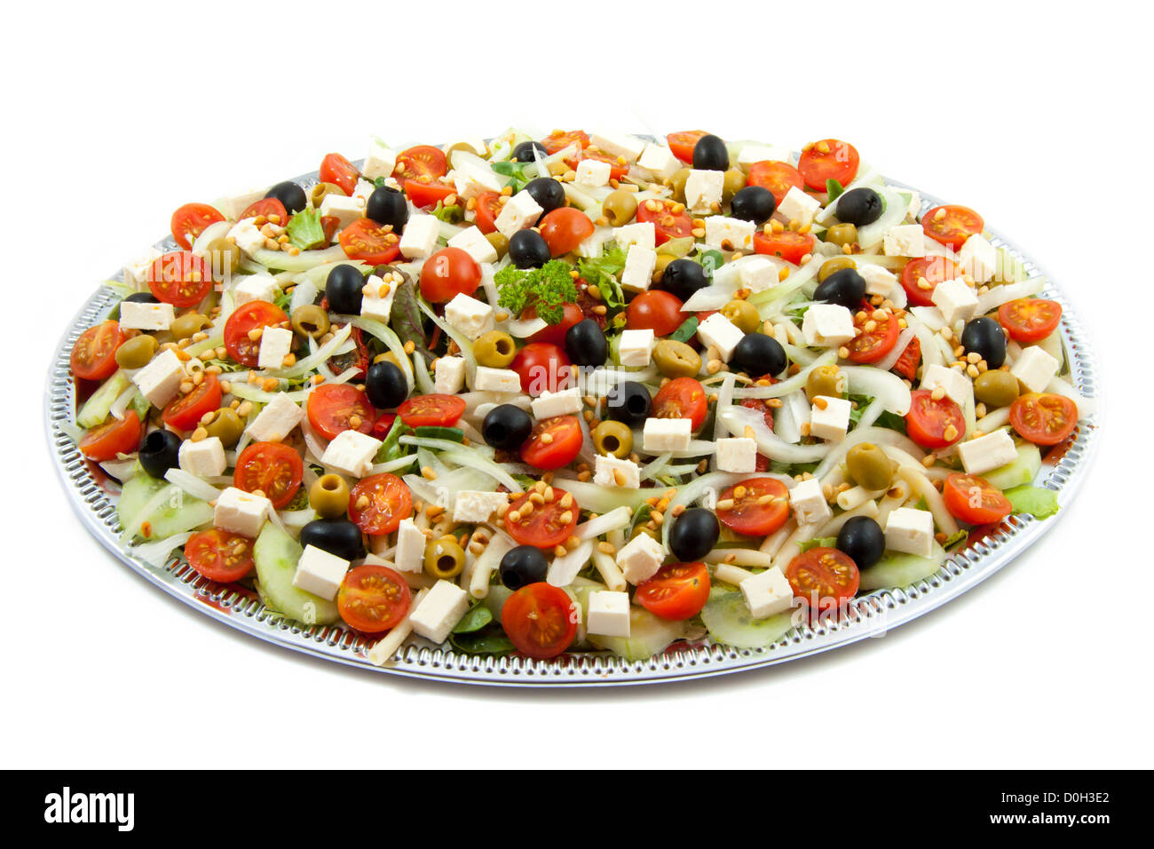 Plate with greek salad isolated over white Stock Photo