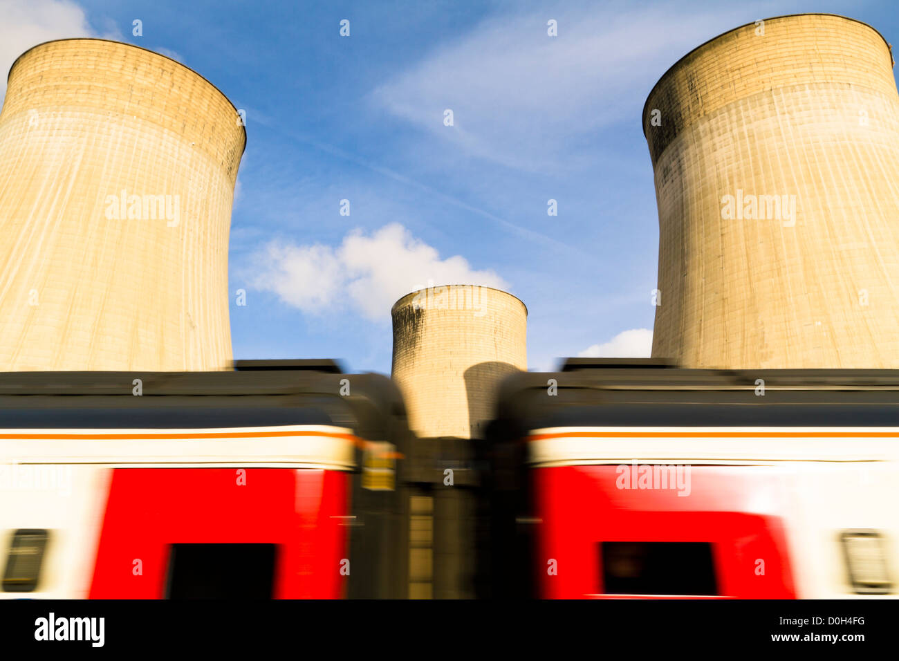 Energy and rail transport industry. Fast HST train passing Ratcliffe on Soar power station cooling towers, Nottinghamshire, England, UK Stock Photo