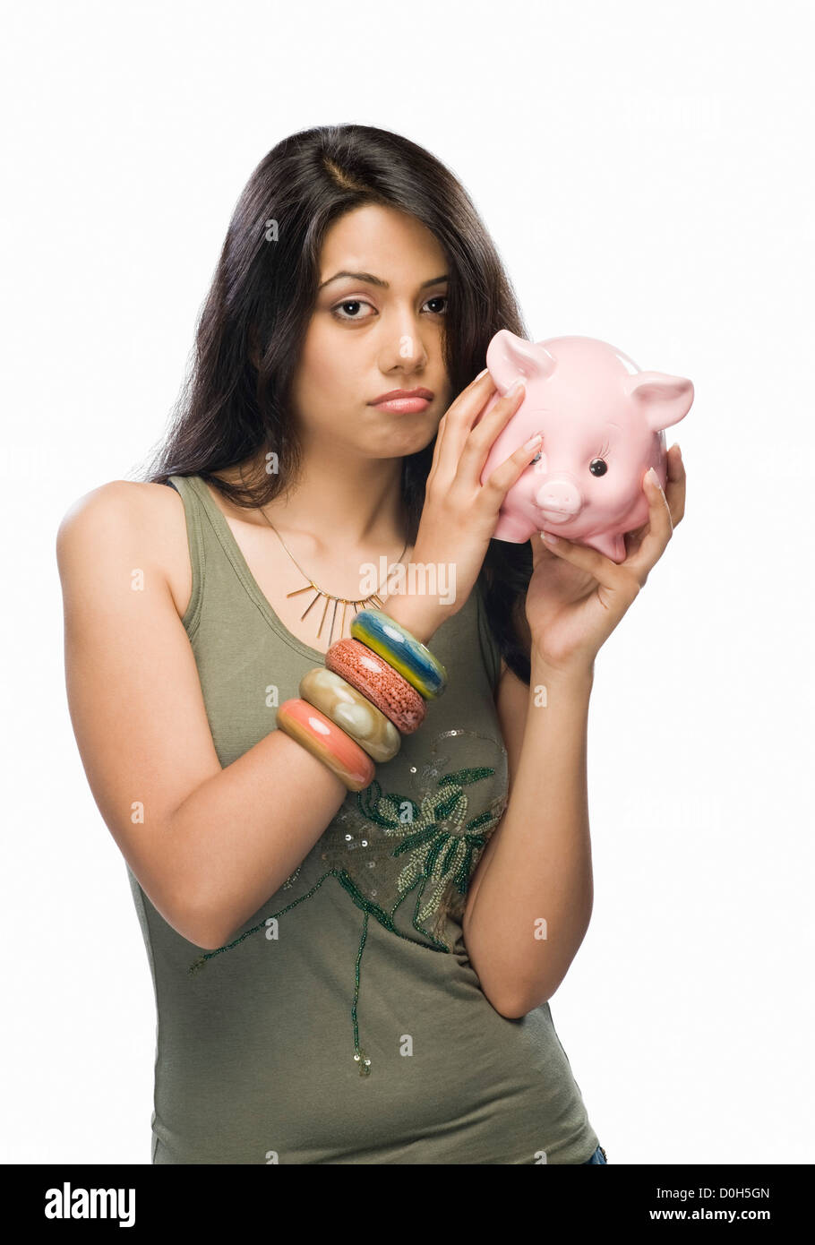 Portrait of a young woman worried with a piggy bank Stock Photo - Alamy