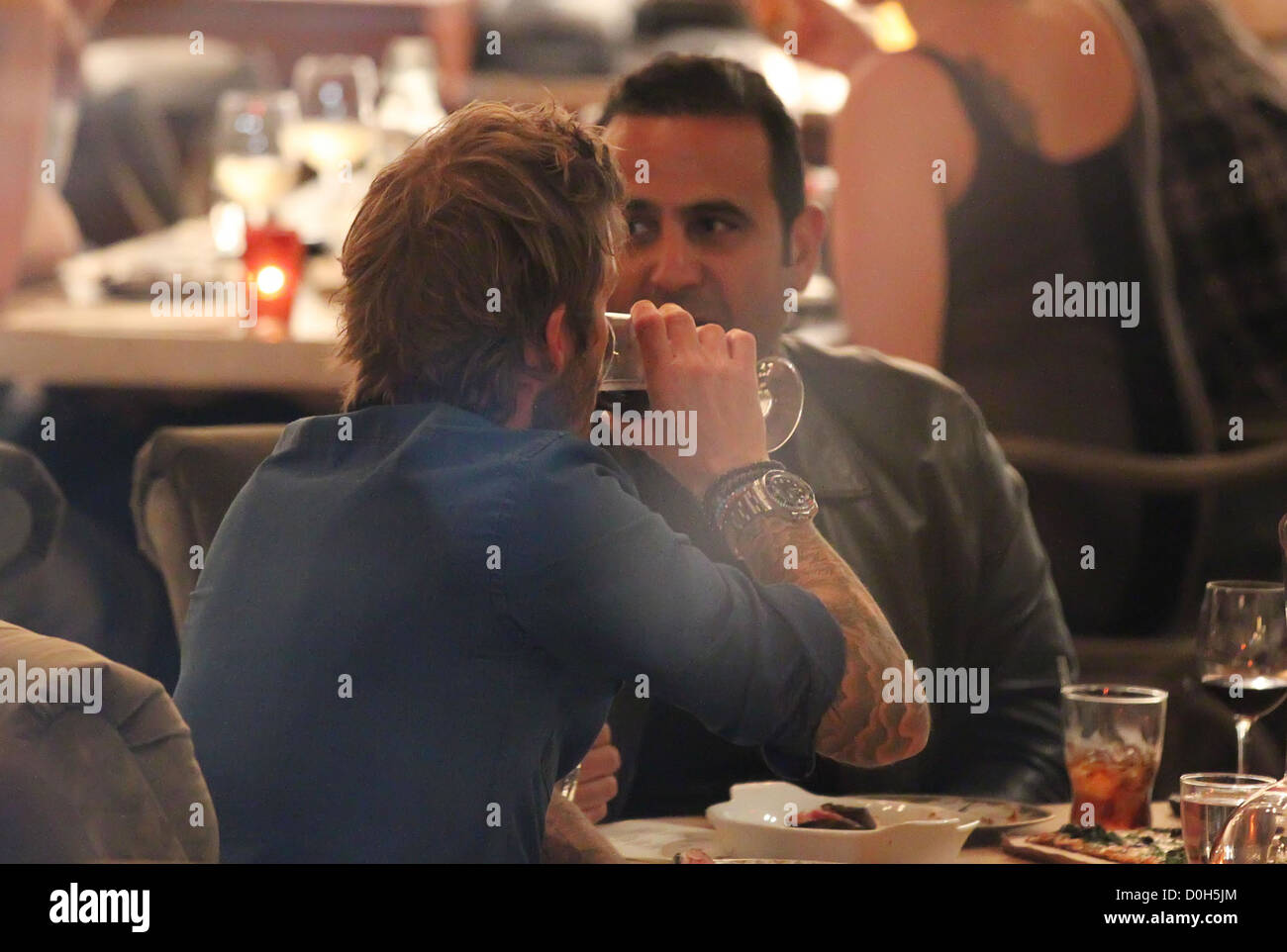 David Beckham having dinner with Iranian-American entrepreneur Sam Nazarian at Cleo restaurant in Hollywood Los Angeles, Stock Photo
