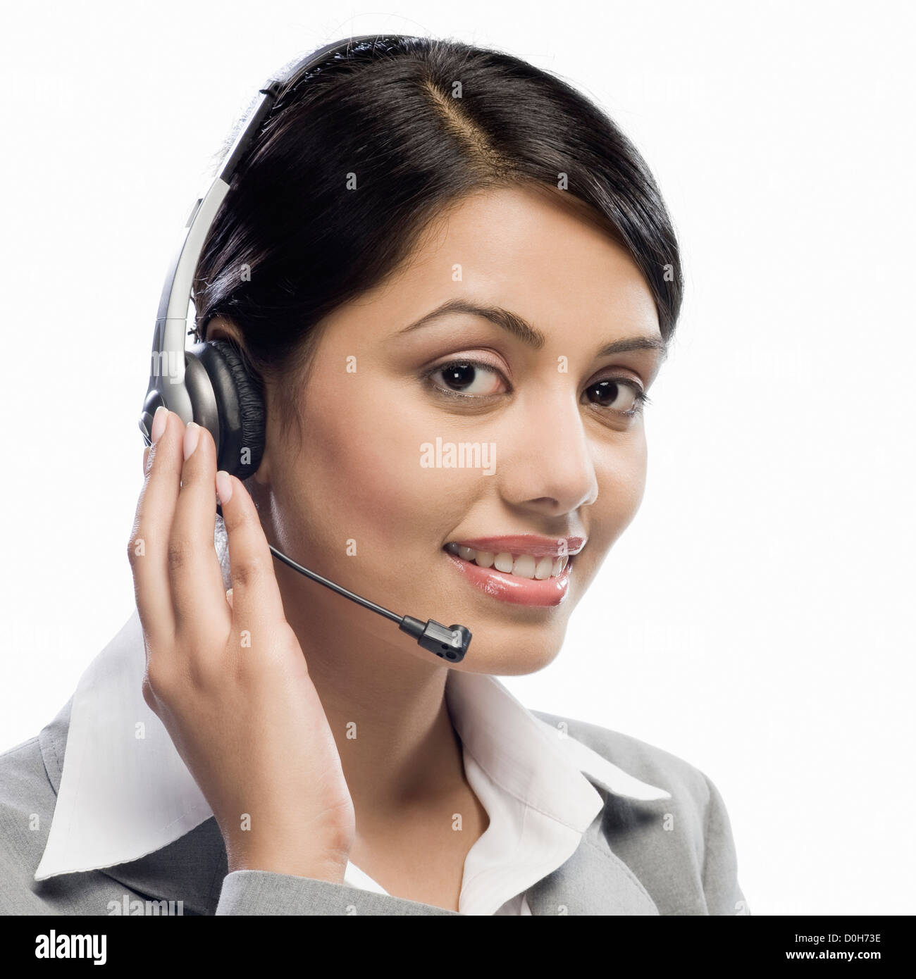 Female customer care executive wearing a headset against a white background Stock Photo Alamy