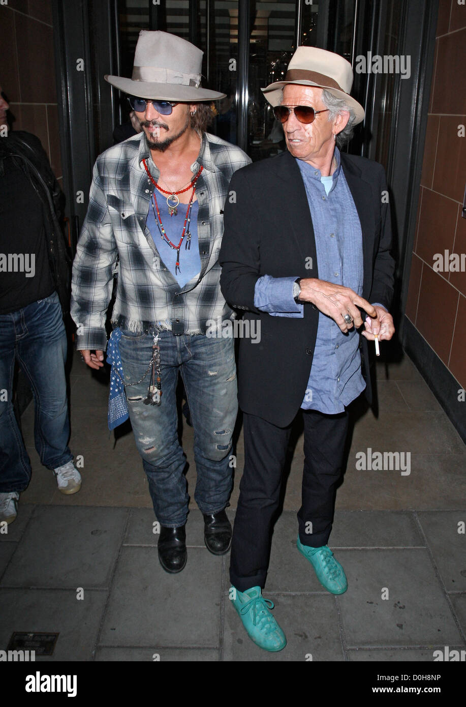 Johnny Depp who seems to be still wearing movie makeup of cuts and bruises leaves C London restaurant with Keith Richards, both Stock Photo