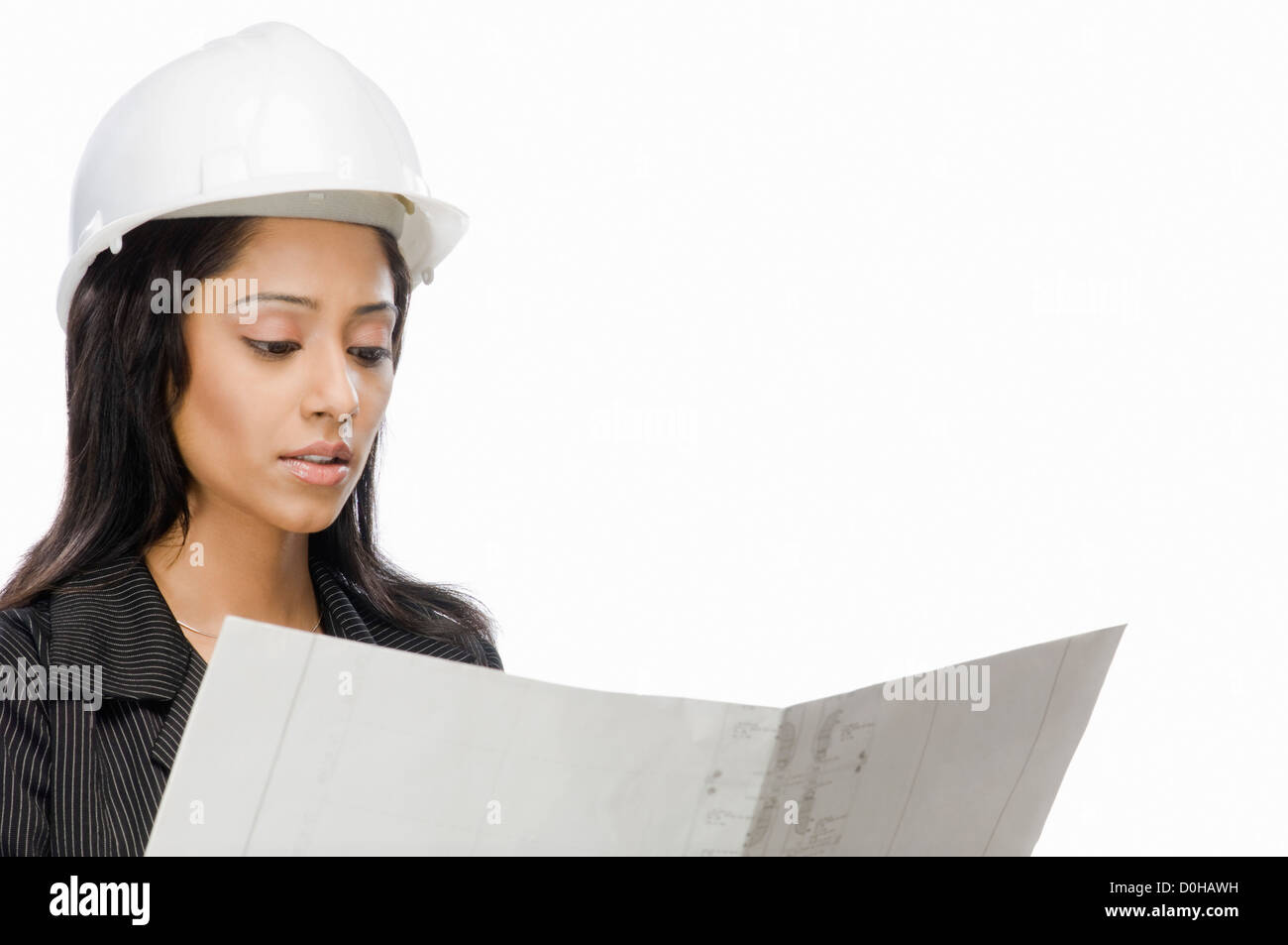 Female architect looking at a blueprint Stock Photo - Alamy