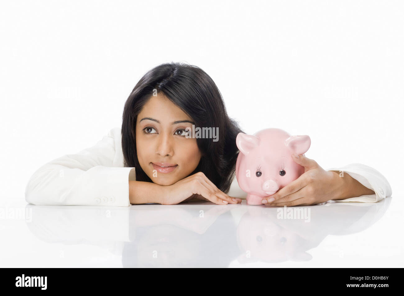 Businesswoman with a piggy bank Stock Photo - Alamy