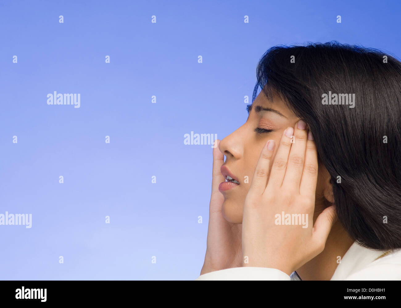 Frustrated businesswoman with her head in her hands Stock Photo