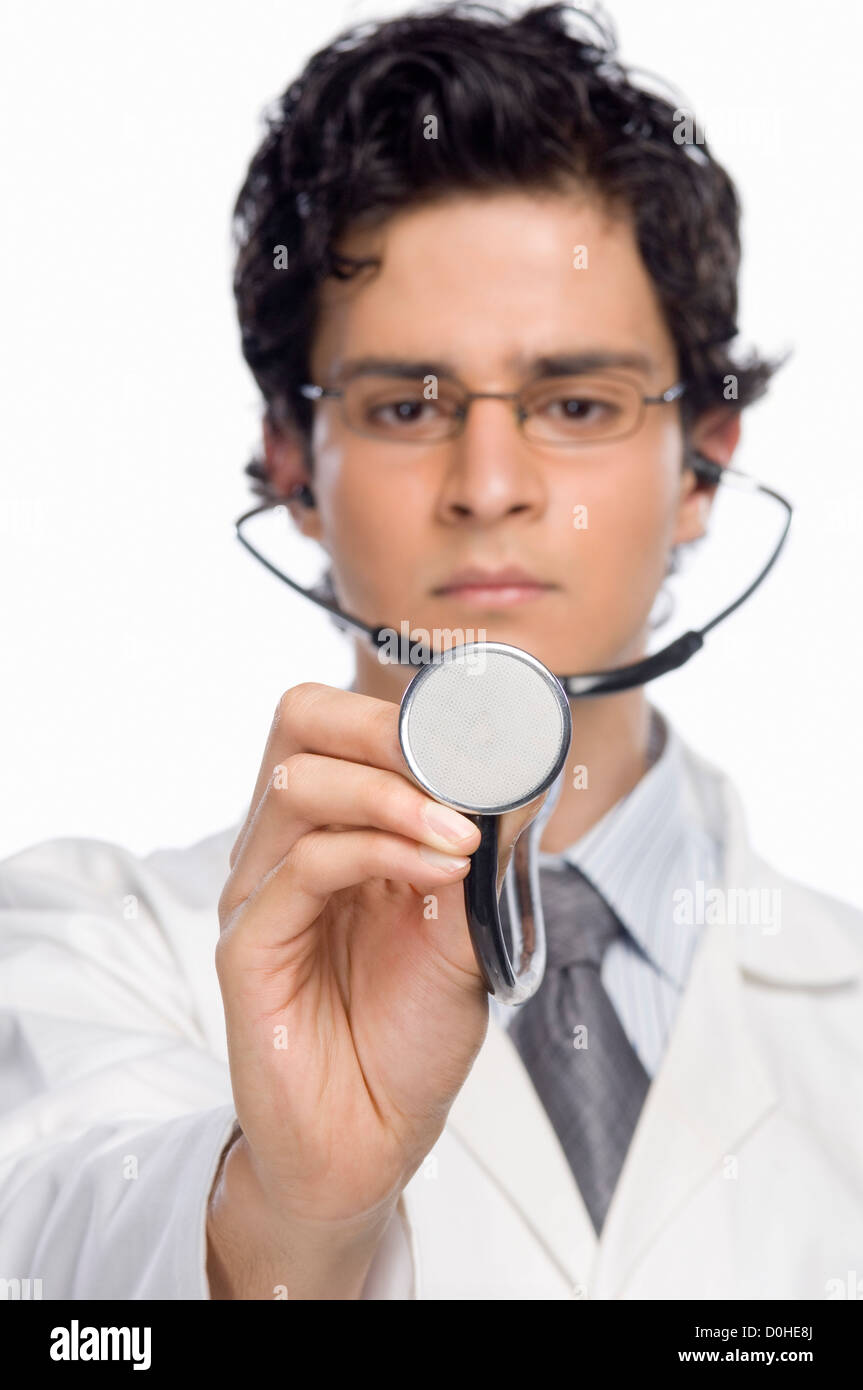 Male doctor holding a stethoscope Stock Photo - Alamy