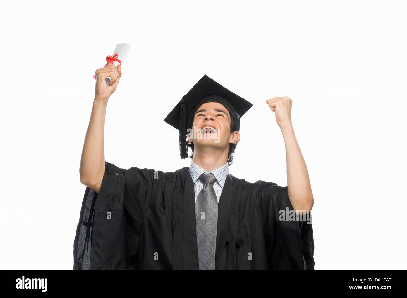 Happy male graduate holding his diploma Stock Photo - Alamy