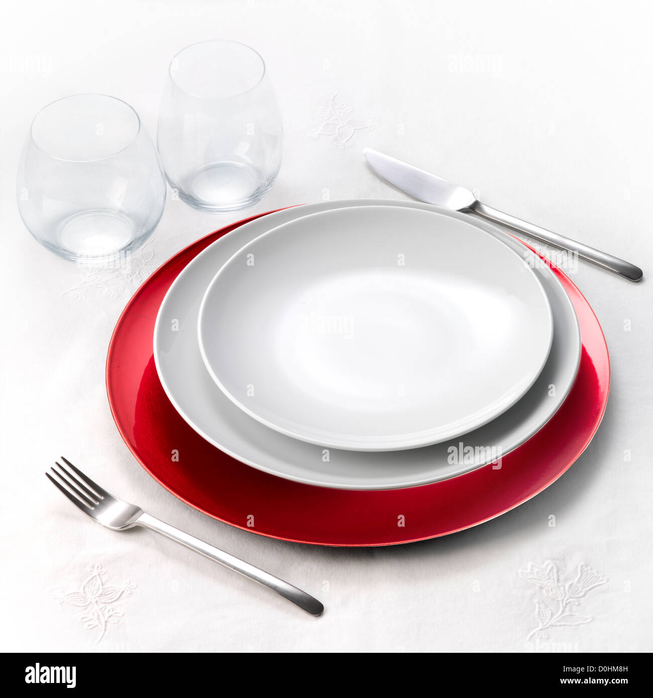 Dinner set on white tablecloth Stock Photo