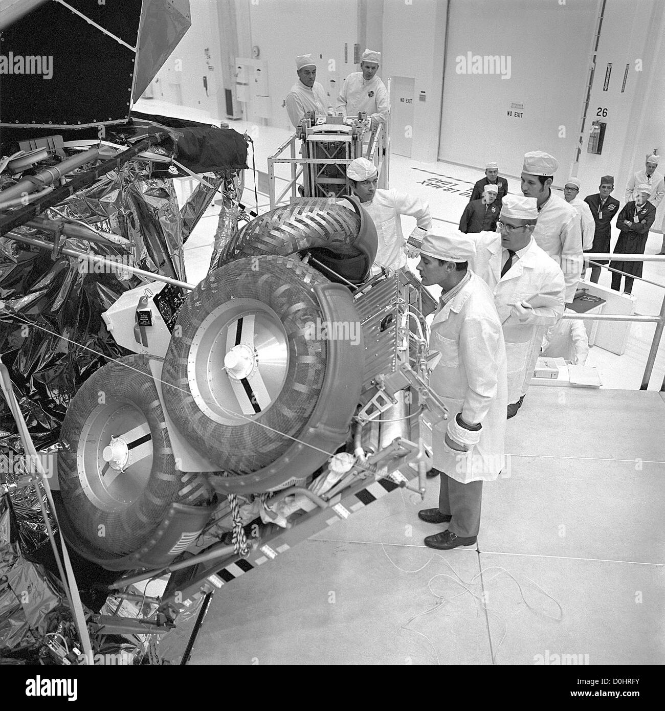 Apollo 16 Commander, John Young, center; and Lunar Module Pilot Charles Duke, foreground, inspect the Lunar Roving Vehicle they Stock Photo
