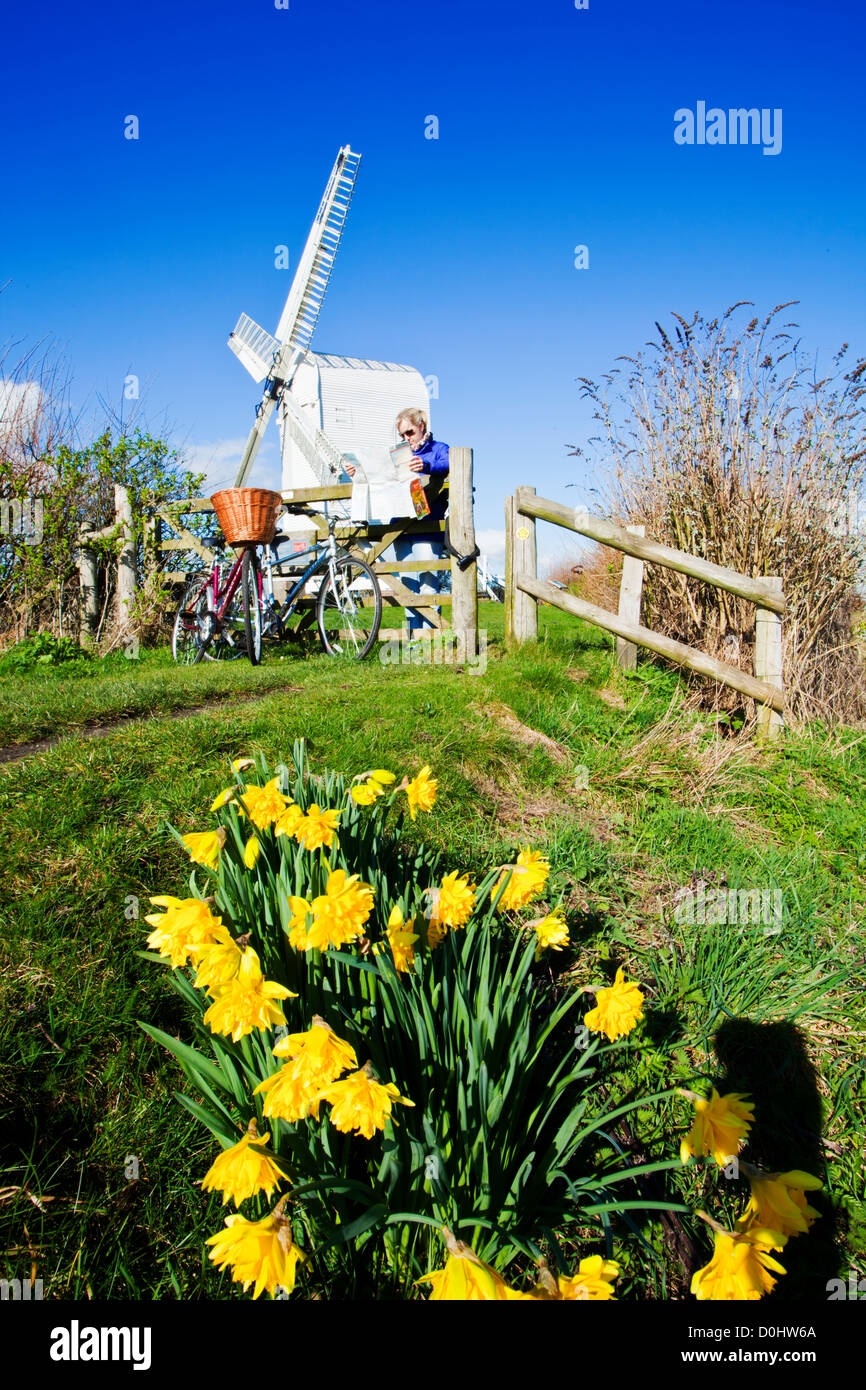 A lady reading a map by her bicycles in front of the weatherboard windmill at Chillenden. Stock Photo
