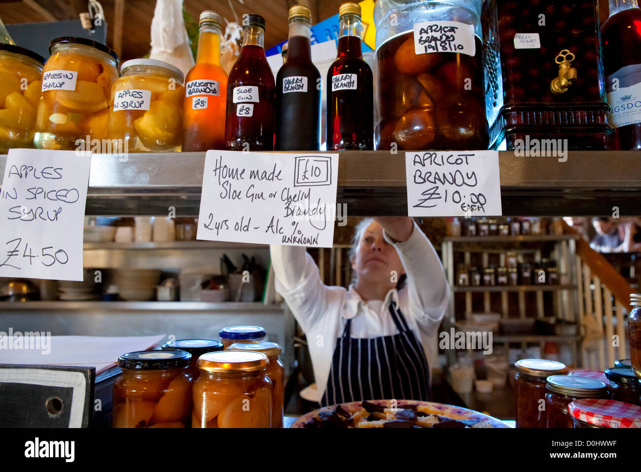 A market trader places food on display at her stall in the Goods Shed in Canterbury. Stock Photo