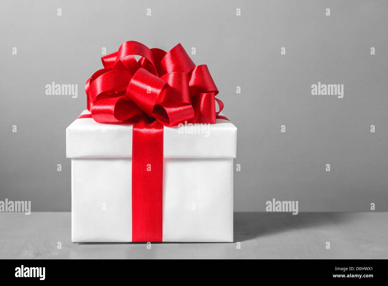 White gift box with red ribbon bow Stock Photo - Alamy