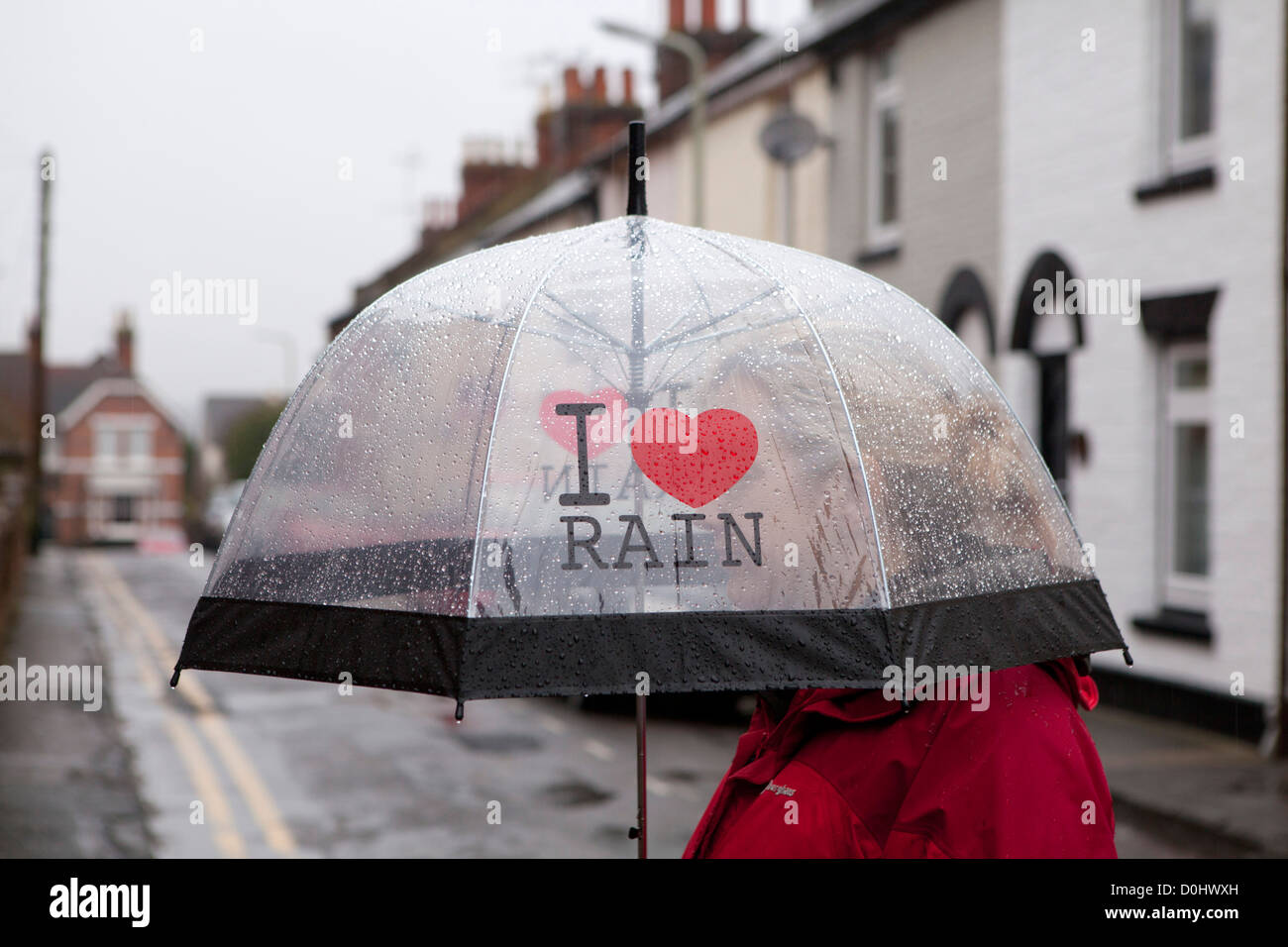 A woman under an umbrella that says I Love Rain. Stock Photo