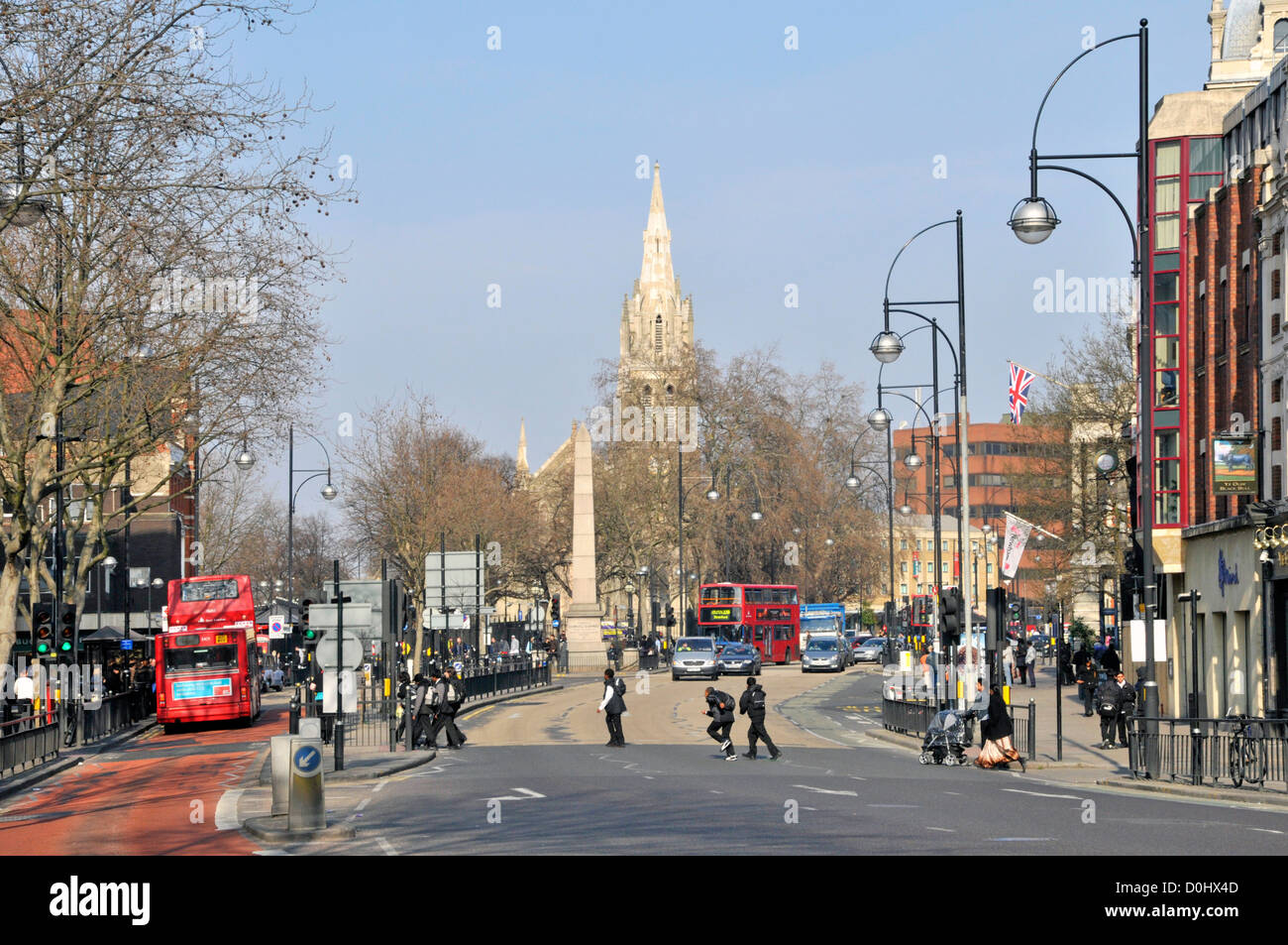 High Street Broadway one way traffic flow on the A11 road with spire of St Johns church Stratford Newham East London England UK Stock Photo