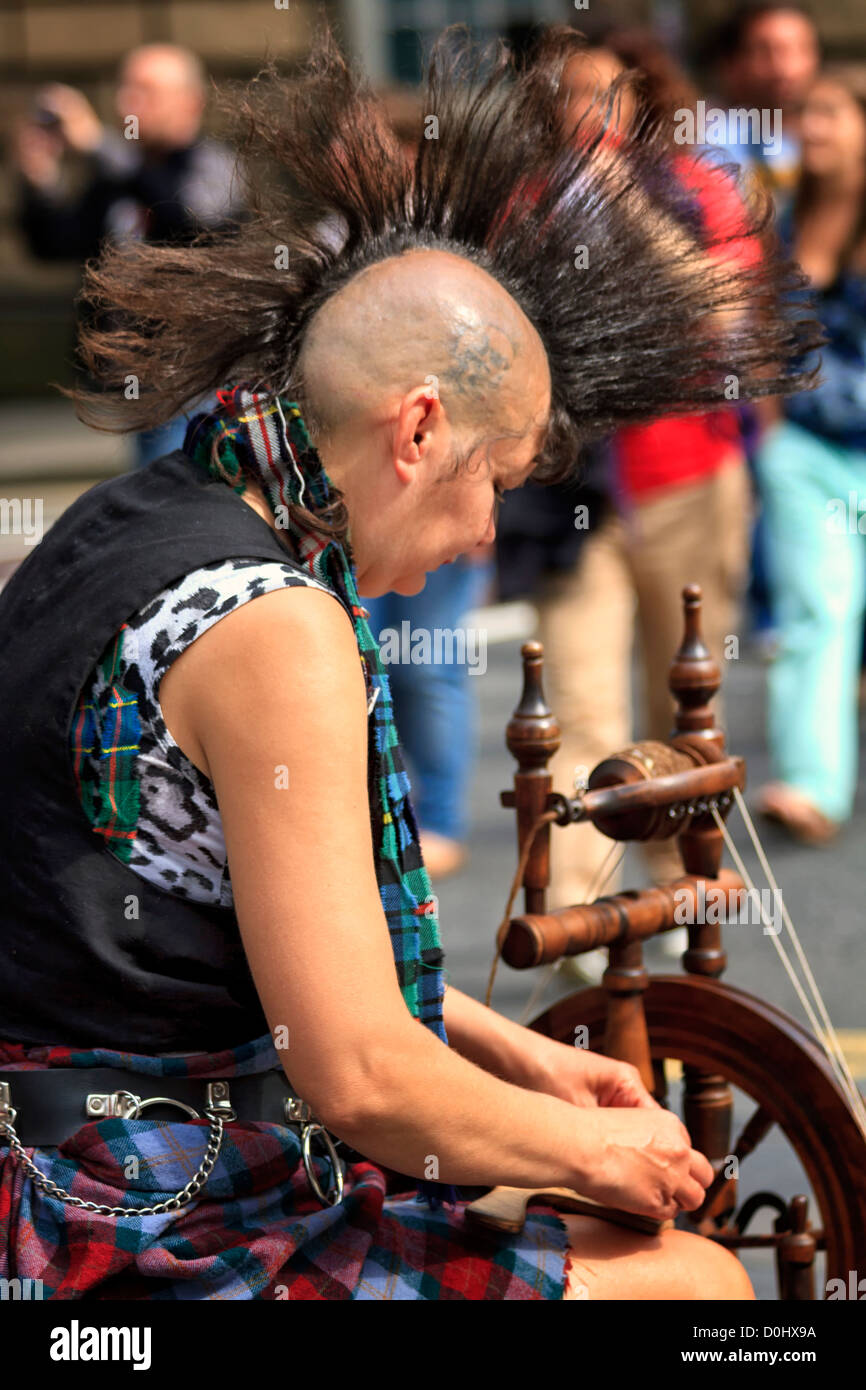 Woman with Mohican hairstyle spinning yarn, Edinburgh, Scotland Stock
