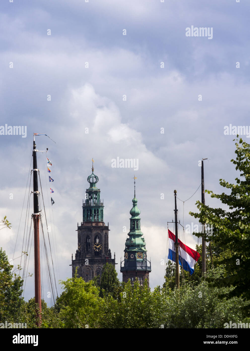 Dutch cityscape with church towers, boat masts and Dutch flag Stock Photo