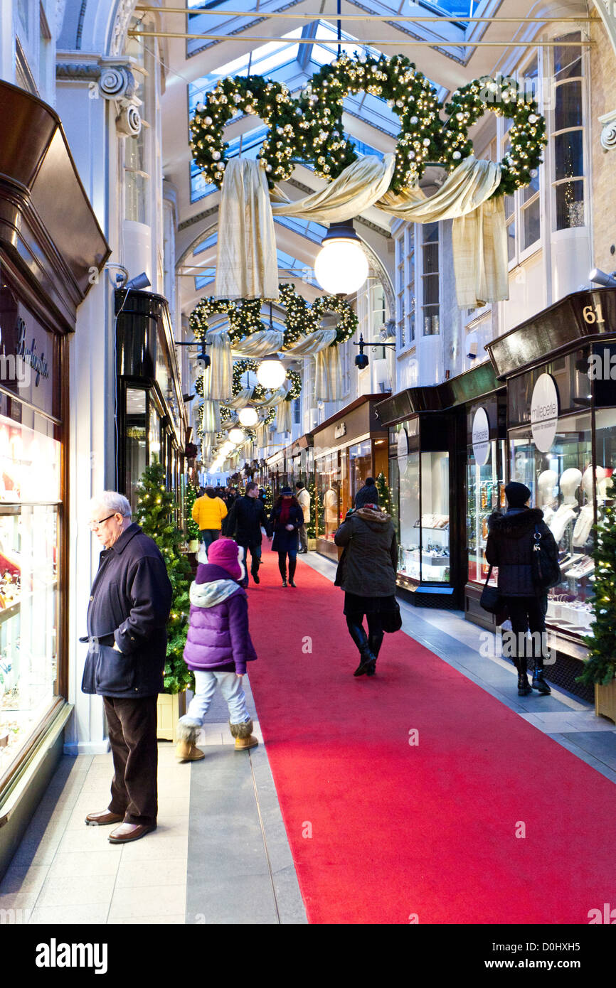 Christmas decorations and shoppers in the Burlington Arcade in London. Stock Photo