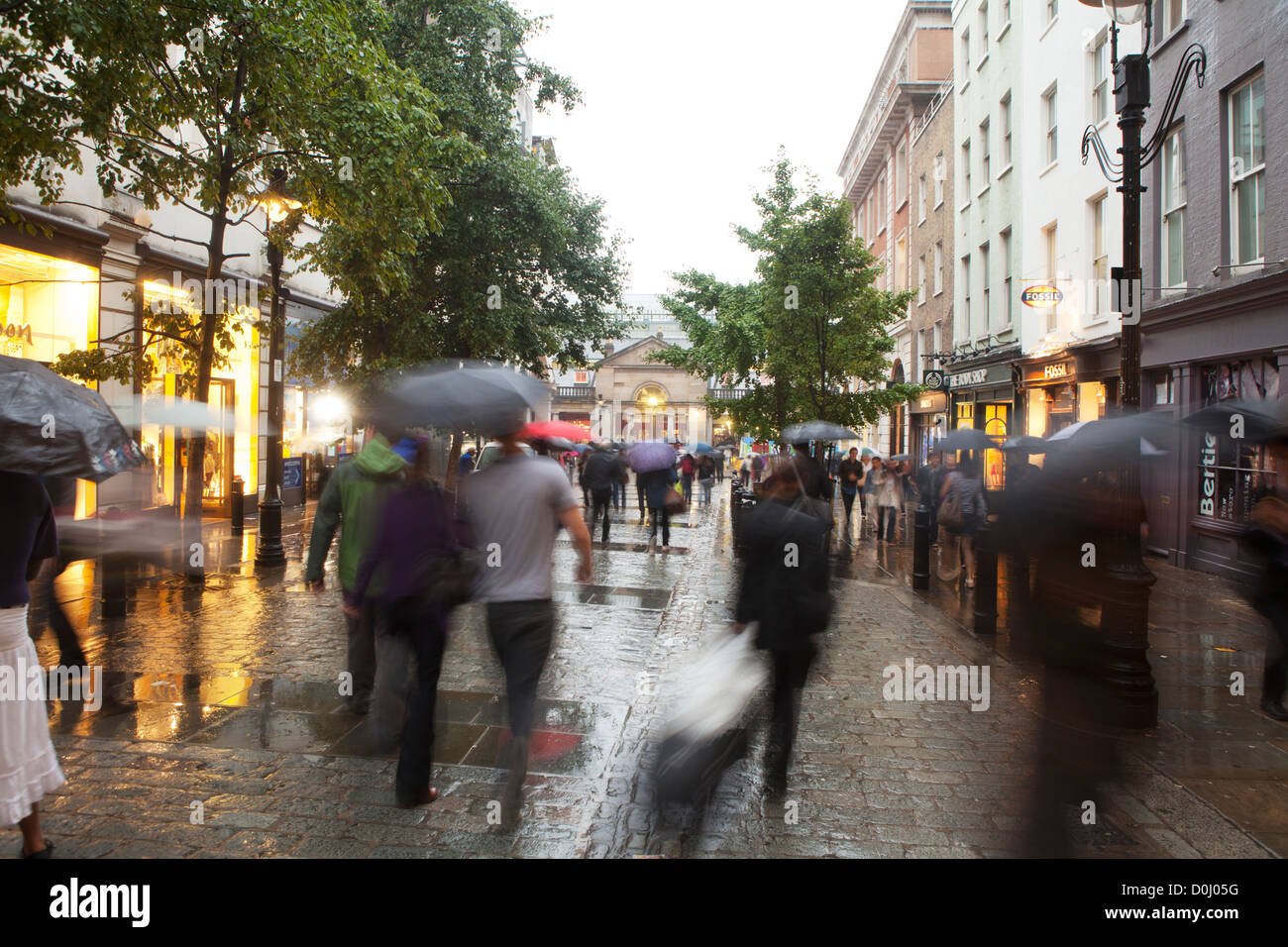 A view of people walking in the rain around Covent Garden. Stock Photo