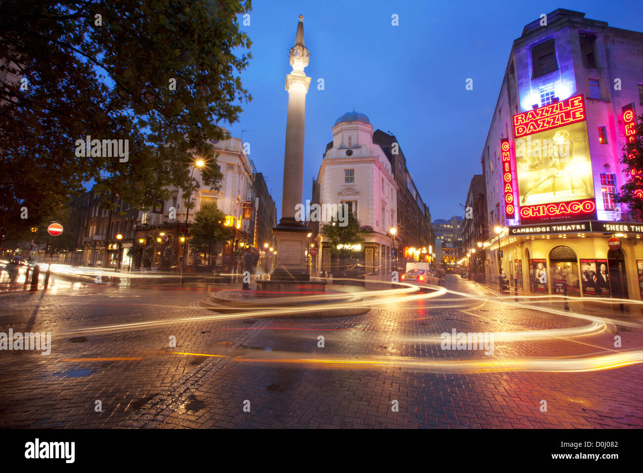 A view of seven dials junction with light trails near the Cambridge Theatre. Stock Photo