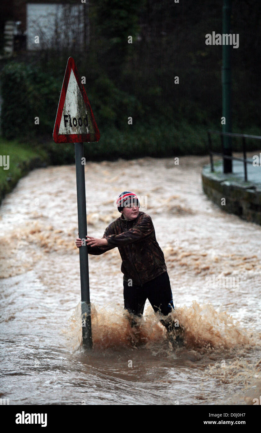 A pedestrian makes his way along a flooded Dam Street in Loftus, East Cleveland, UK. 24/11/2012. Photograph: Stuart Boulton. Stock Photo