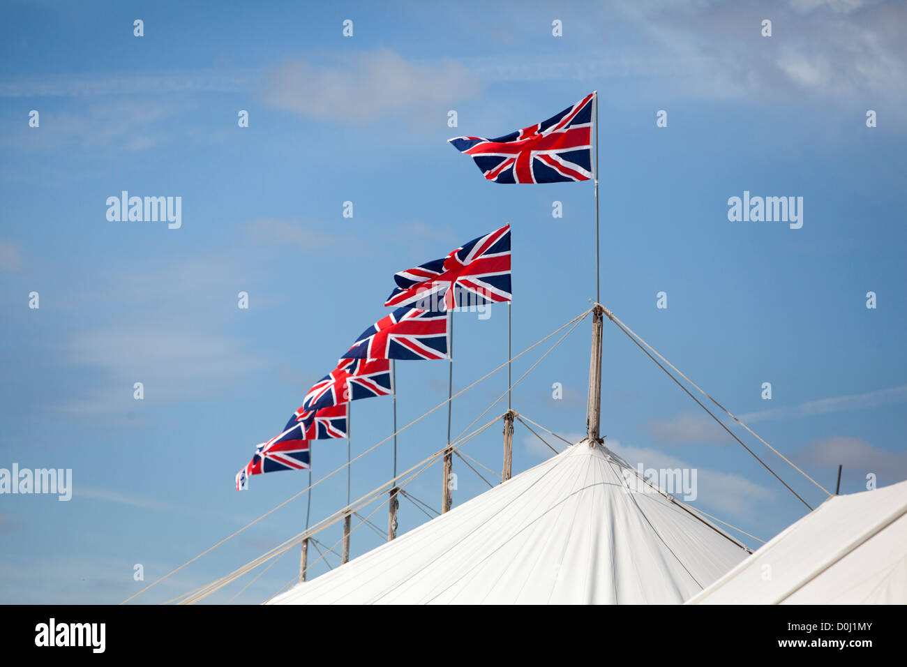 A series of Union Jack flags on top of a marquee at Goodwood revival. Stock Photo