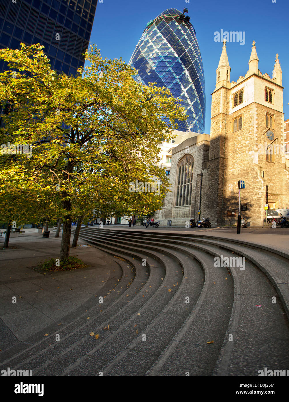 A view of the Swiss Re tower and St Andrew Undershaft church beneath it. Stock Photo