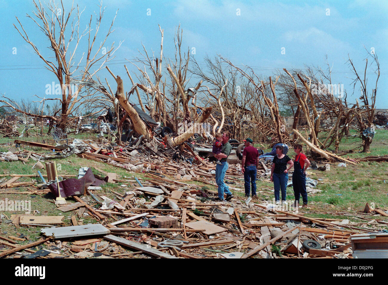 A Family Surveys the Destruction of Their Home and Property Stock Photo