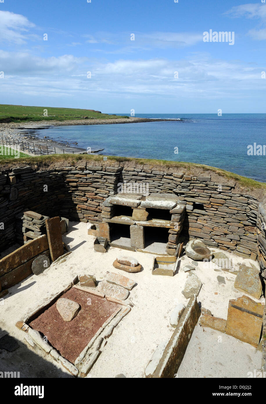 The interior of a four or five thousand year old neolithic house at Skara Brae showing shelves, fireplace and beds. Stock Photo