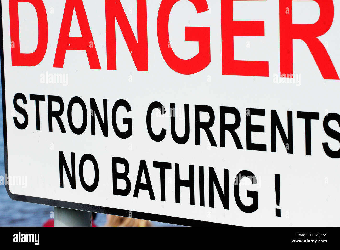 A sign warning of the dangers of swimming in strong currents Stock